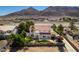 Well-maintained property with a private pool and lush landscaping, and mountain views at 1345 Morning Sun Way, Las Vegas, NV 89110