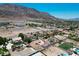 Spacious lots with neighboring homes and desert landscape beneath a mountain range at 1345 Morning Sun Way, Las Vegas, NV 89110