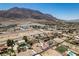 Aerial showcasing desert landscaping with mature trees and nearby mountain views in the neighborhood at 1345 Morning Sun Way, Las Vegas, NV 89110