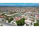 Neighborhood aerial view with single Gathering homes, desert landscaping, and a distant city skyline at 1345 Morning Sun Way, Las Vegas, NV 89110