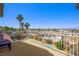 The balcony overlooks a city view with a metal fence, lush greenery, and comfortable seating at 1345 Morning Sun Way, Las Vegas, NV 89110