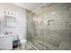 Bathroom featuring a glass enclosed shower with modern fixtures, next to a toilet and sink at 1345 Morning Sun Way, Las Vegas, NV 89110