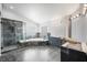 Beautiful primary bath featuring granite surfaces, glass shower, and jacuzzi tub at 1345 Morning Sun Way, Las Vegas, NV 89110