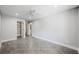 Spacious bedroom featuring tile floors, a ceiling fan, and an open closet space at 1345 Morning Sun Way, Las Vegas, NV 89110