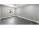 Bright bedroom with a ceiling fan, tile floors and natural light from the large window at 1345 Morning Sun Way, Las Vegas, NV 89110