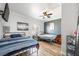 Spacious bedroom featuring two beds, hardwood floors, and a ceiling fan with views to the exterior at 1345 Morning Sun Way, Las Vegas, NV 89110
