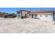 Single story home with a long driveway and garage, desert landscaping, with multiple exterior doors at 1345 Morning Sun Way, Las Vegas, NV 89110