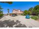 Spacious two-story home with a long driveway, carport, and desert landscaping under a clear blue sky at 1345 Morning Sun Way, Las Vegas, NV 89110
