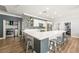 Modern kitchen featuring a large quartz island, updated appliances, and adjacent laundry room at 1345 Morning Sun Way, Las Vegas, NV 89110