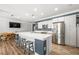 Open-concept kitchen showcasing a large island with seating, modern appliances, and a casual dining area at 1345 Morning Sun Way, Las Vegas, NV 89110