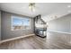 Inviting living room with a fireplace, wood floors, and great natural light from the window at 1345 Morning Sun Way, Las Vegas, NV 89110