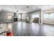 Open-concept living area with modern fireplace, tile floors, and lots of natural light at 1345 Morning Sun Way, Las Vegas, NV 89110