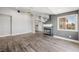 Open-concept living room with wood floors, a statement fireplace, and ample natural light at 1345 Morning Sun Way, Las Vegas, NV 89110