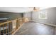 Cozy loft featuring wood floors, a wooden railing, and plenty of natural light at 1345 Morning Sun Way, Las Vegas, NV 89110