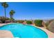 Inviting backyard pool featuring a rock waterfall, mature landscaping and desert views at 1345 Morning Sun Way, Las Vegas, NV 89110