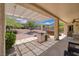 Outdoor space featuring covered patio, built-in grill, lush landscaping and spa at 1620 Fieldbrook St, Henderson, NV 89052