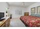 Relaxing bedroom with neutral carpet, an exit door, a wooden dresser, and ample natural light at 1620 Fieldbrook St, Henderson, NV 89052