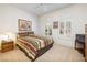 Inviting bedroom with neutral carpet, plantation shutters, and charming desert artwork at 1620 Fieldbrook St, Henderson, NV 89052
