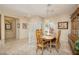 Inviting dining room features neutral tones, tile floors, a wooden table, and a decorative hutch, creating a warm and welcoming space at 1620 Fieldbrook St, Henderson, NV 89052