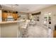 Cozy breakfast nook with white chairs, a glass table, and a breakfast bar, adjoining a kitchen with oak cabinets at 1620 Fieldbrook St, Henderson, NV 89052