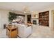 Comfortable living room featuring a fireplace, built-in bookshelves, and backyard views at 1620 Fieldbrook St, Henderson, NV 89052