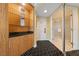Condo hallway with decorative shelving, white door, and bathroom entrance featuring patterned black and white carpeting at 2000 N Fashion Show Dr # 2704, Las Vegas, NV 89109