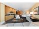 Comfortable living room with kitchenette with black countertops, microwave, TV and patterned black and white carpeting at 2000 N Fashion Show Dr # 2704, Las Vegas, NV 89109