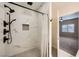 Modern bathroom with a white marble tiled shower featuring matte black hardware and a tiled soap niche at 2108 Calville St # 104, Las Vegas, NV 89128