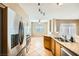 Kitchen with stainless steel appliances and granite countertops with an open view to the breakfast nook and living room at 2108 Calville St # 104, Las Vegas, NV 89128
