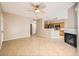 Bright living room featuring tile flooring, a ceiling fan, and a cozy fireplace at 2108 Calville St # 104, Las Vegas, NV 89128