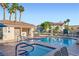 Community pool with hot tub, seating, and bathroom facilities surrounded by palm trees at 2108 Calville St # 104, Las Vegas, NV 89128