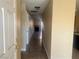 View through home's front door of hallway with tile floors and fireplace at end at 228 Caracas Dr, Las Vegas, NV 89145