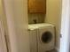 Convenient laundry area complete with front loading washer and dryer and overhead cabinets at 228 Caracas Dr, Las Vegas, NV 89145