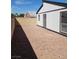 Unlandscaped backyard featuring a rock ground and a white wall at 2318 El Molino Cir, Las Vegas, NV 89108