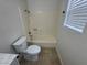 Bathroom featuring a bright tub and a window with blinds to allow natural light at 2318 El Molino Cir, Las Vegas, NV 89108
