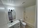 Bathroom featuring a bright vanity, a modern mirror and a tub with a shower at 2318 El Molino Cir, Las Vegas, NV 89108