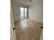 Well-lit bedroom featuring neutral tile flooring and a glass sliding door to the outside at 2318 El Molino Cir, Las Vegas, NV 89108