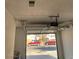 Garage featuring an automatic garage door with an outdoor view of parked cars at 2318 El Molino Cir, Las Vegas, NV 89108