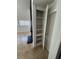 Hallway featuring an open shelf cabinet with multiple shelves and a fireplace at 2318 El Molino Cir, Las Vegas, NV 89108