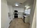 Bright kitchen features stainless steel appliances, white cabinets and tile flooring at 2318 El Molino Cir, Las Vegas, NV 89108