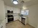 Updated kitchen with stainless steel appliances, white cabinets and a window at 2318 El Molino Cir, Las Vegas, NV 89108