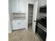 Kitchen features stainless steel oven and microwave, white cabinets and flooring at 2318 El Molino Cir, Las Vegas, NV 89108