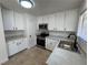 Updated kitchen with stainless steel appliances, white cabinets and tile flooring at 2318 El Molino Cir, Las Vegas, NV 89108