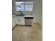 Stainless steel sink and dishwasher with white cabinets, counters and flooring at 2318 El Molino Cir, Las Vegas, NV 89108