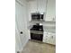 Updated kitchen featuring stainless steel appliances, white cabinets, and tile flooring at 2318 El Molino Cir, Las Vegas, NV 89108