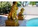 Backyard featuring a sparkling pool and two golden lion statues at 2659 Vegas Valley Dr, Las Vegas, NV 89121