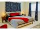 This bedroom has a comfy queen bed and features modern patterned curtains and tile flooring at 2659 Vegas Valley Dr, Las Vegas, NV 89121