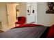 Comfortable bedroom with a red accent chair and a vanity in the background creating a relaxing and stylish ambiance at 2659 Vegas Valley Dr, Las Vegas, NV 89121