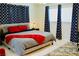 This bedroom has a comfy queen bed and features modern patterned curtains and tile flooring at 2659 Vegas Valley Dr, Las Vegas, NV 89121