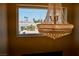 Elegant chandelier illuminating the space with a neighborhood view from the window at 2659 Vegas Valley Dr, Las Vegas, NV 89121